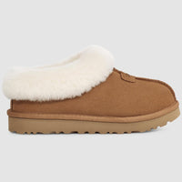 Brown slipper with white fur lining on a light gray background
