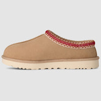Tan slipper with red trim on a light gray background