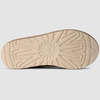 Close-up of a beige shoe sole on a light gray background