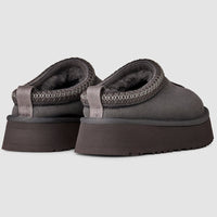 Pair of gray platform sandals on a light gray background