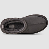 Dark gray UGG slipper on a light gray background