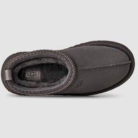 Dark gray UGG slipper on a light gray background