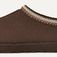 Brown slipper with patterned trim on a white background