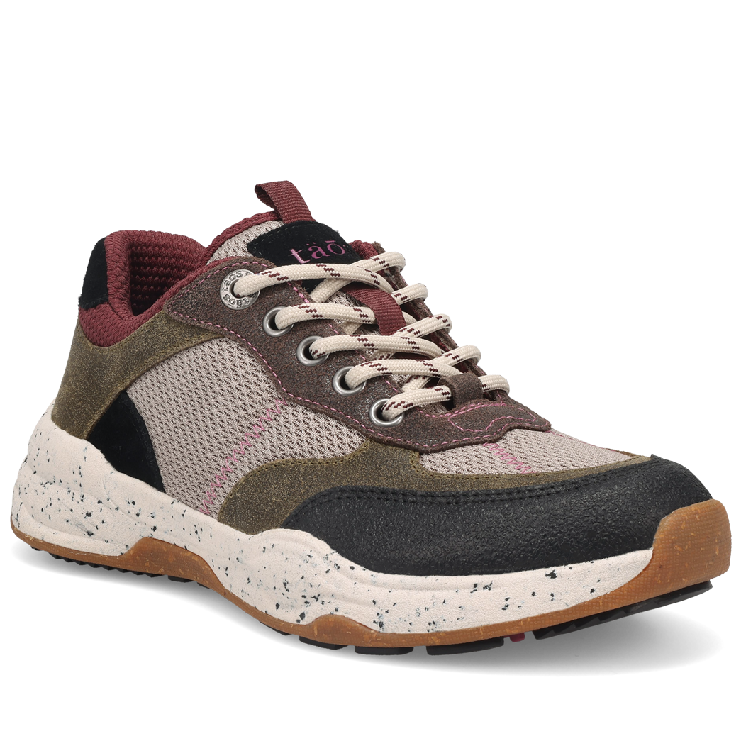 Multicolored sneaker with brown, black, and beige accents on a white background