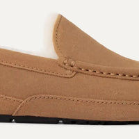 Brown loafer shoe on a light gray background