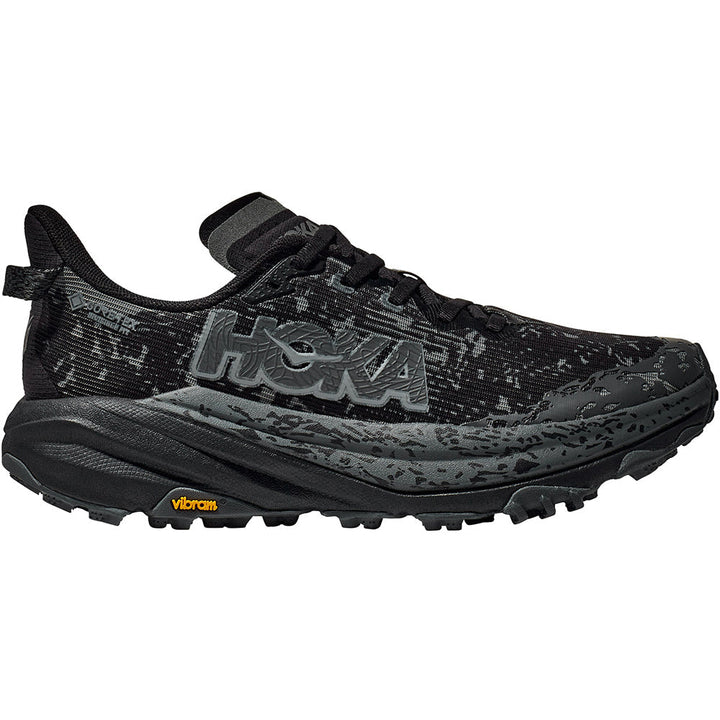 Quarter turn view Women's Hoka Footwear style name Speedgoat 6 GTX Wide in color Black/ Outer Orbit. Sku: 1155771BCKT