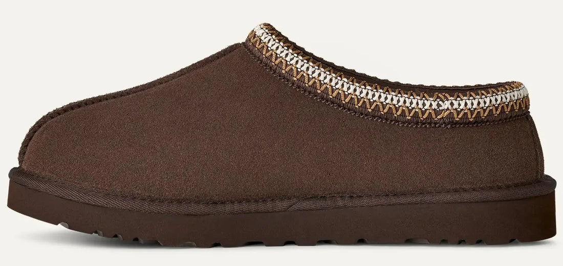 Brown slipper with patterned trim on a white background