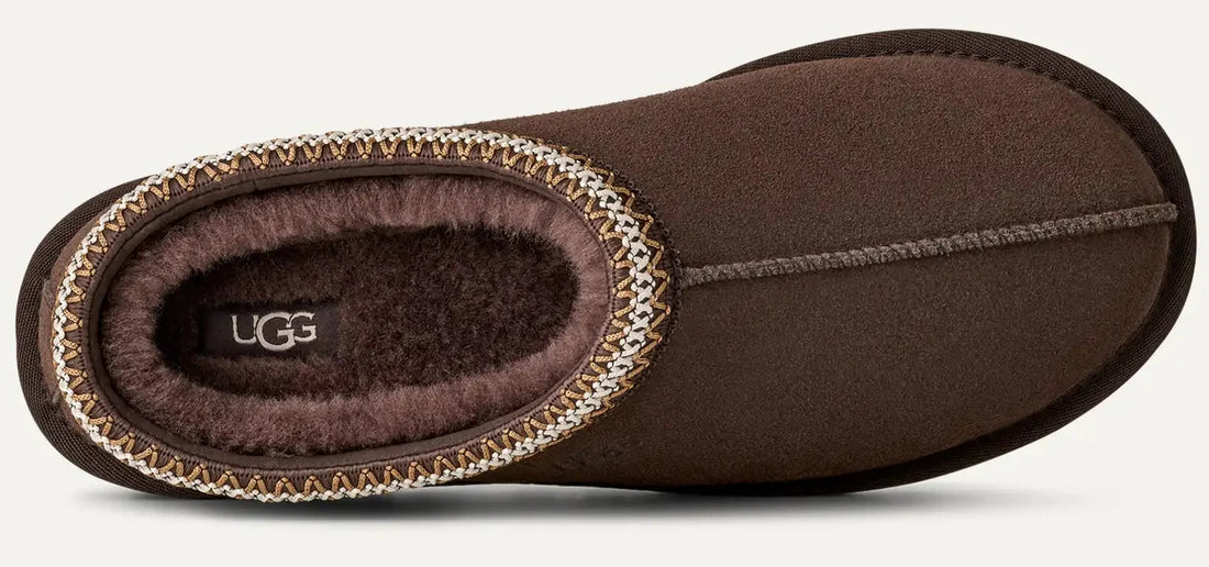 Brown UGG slipper on a light gray background