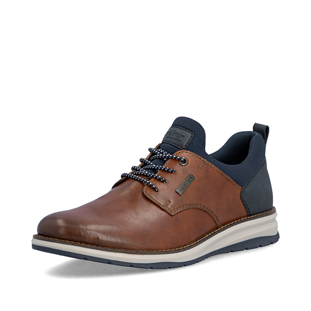 Brown leather shoe with navy accents on a white background