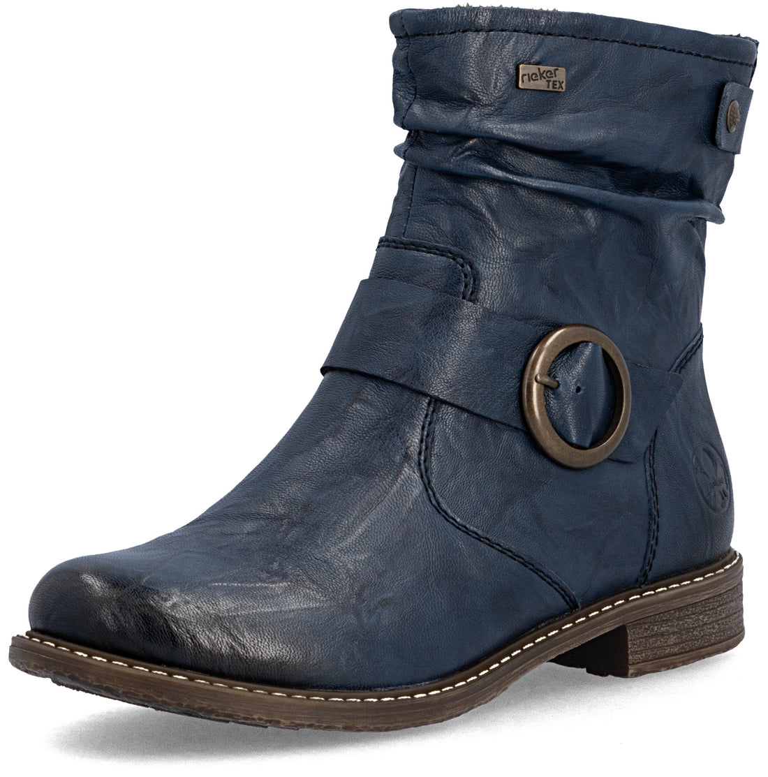A navy blue faux-leather ankle boot with a slouchy top, a decorative strap across the instep featuring a large bronze-colored metal ring, and a low stacked heel.