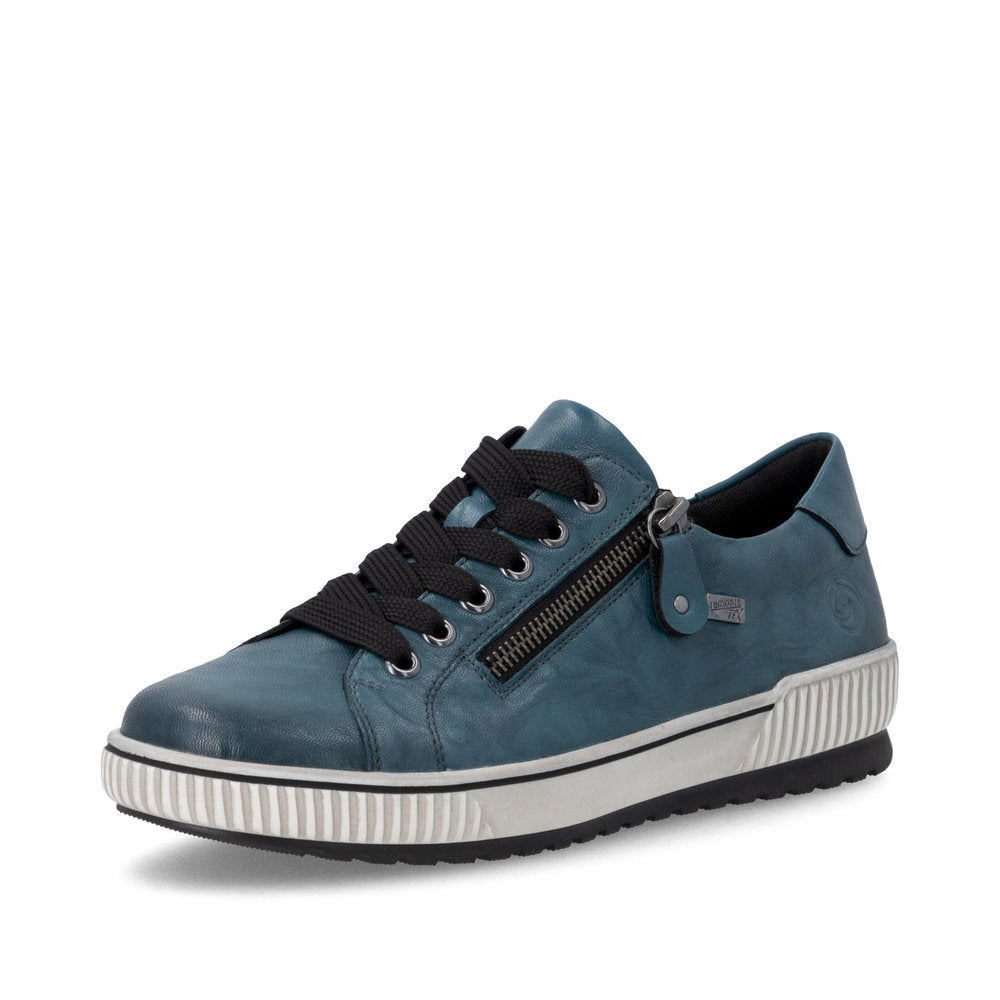 Blue sneaker with black laces and a white sole on a white background