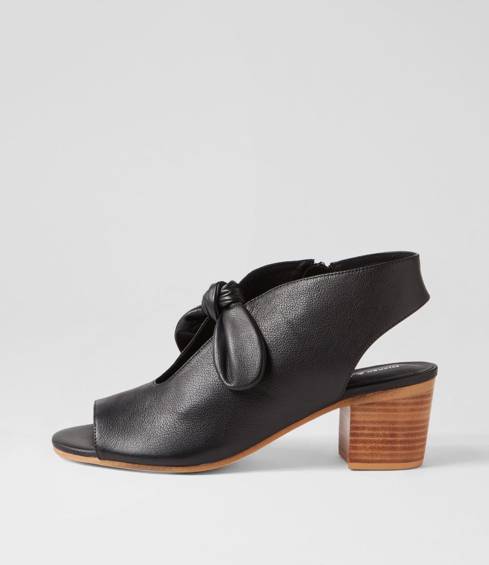 Black sandal with wooden heel on a light gray background