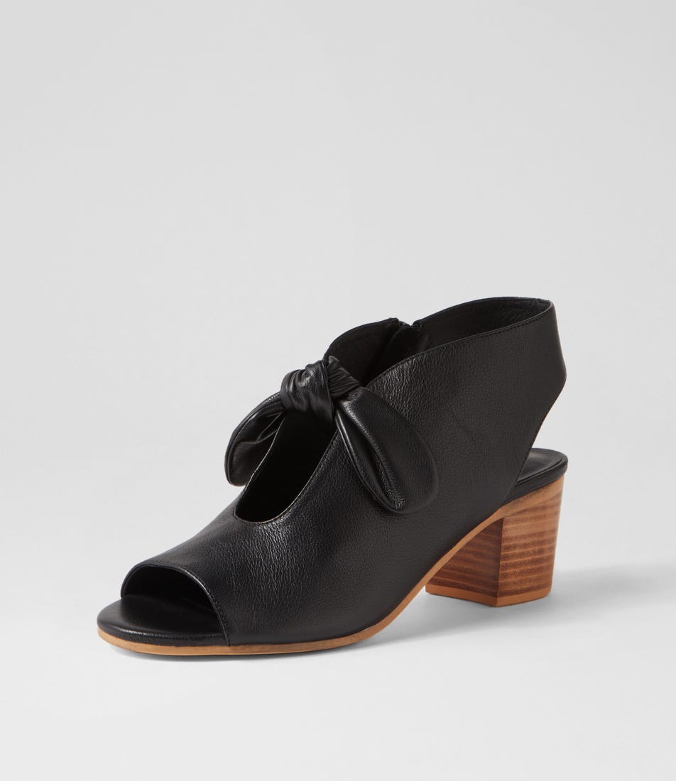 Black open-toe shoe with wooden heel on a light gray background