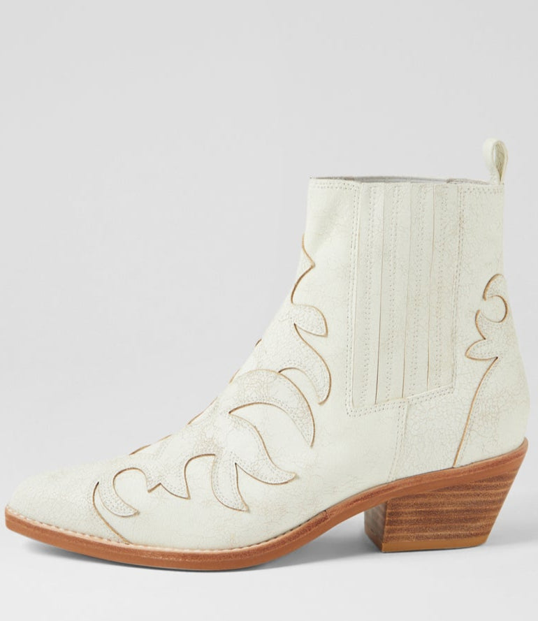 White cowboy boot with brown sole on a light gray background