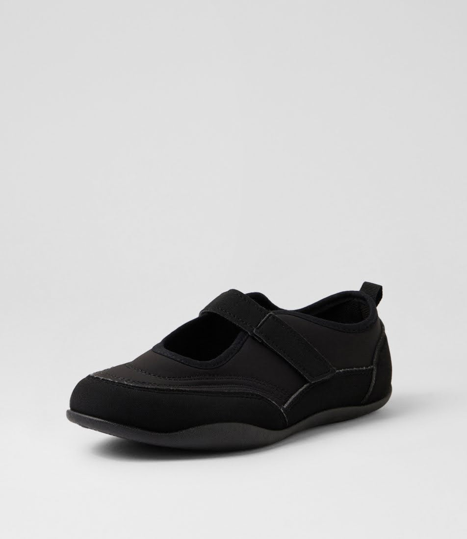 A single black slip-on shoe with a hook-and-loop strap across the top, shown from a three-quarters angle on a light gray studio background.