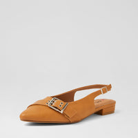 A single tan leather slingback flat shoe with a pointed toe, low block heel, and a decorative silver-tone buckle detail across the instep, shown against a light gray studio background.